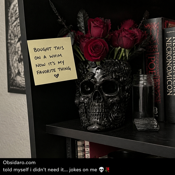 Obsidian Skull Rose Vase with red roses on gothic bookshelf